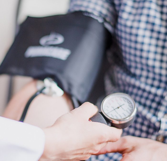 a doctor taking a patients blood pressure
